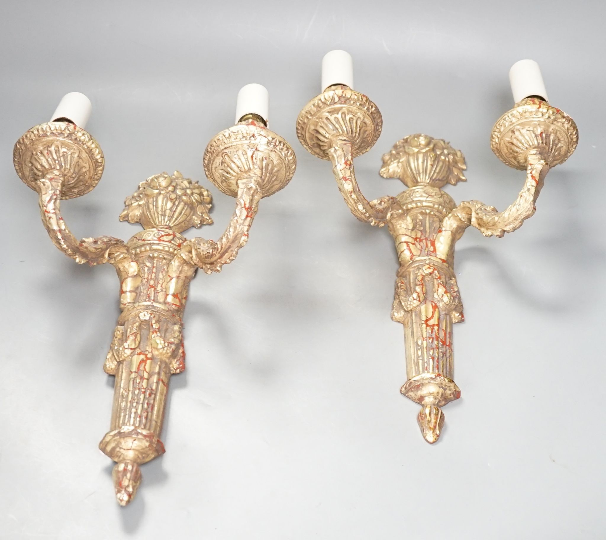 A pair of neo-classical style gilt composition twin-light wall sconces, 38cm